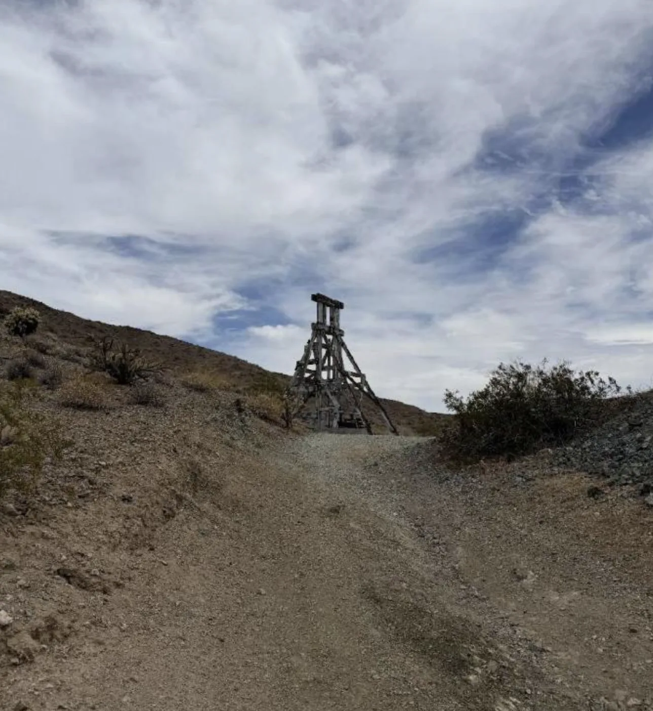 Historic timber headframe standing above the main shaft on the ridge.