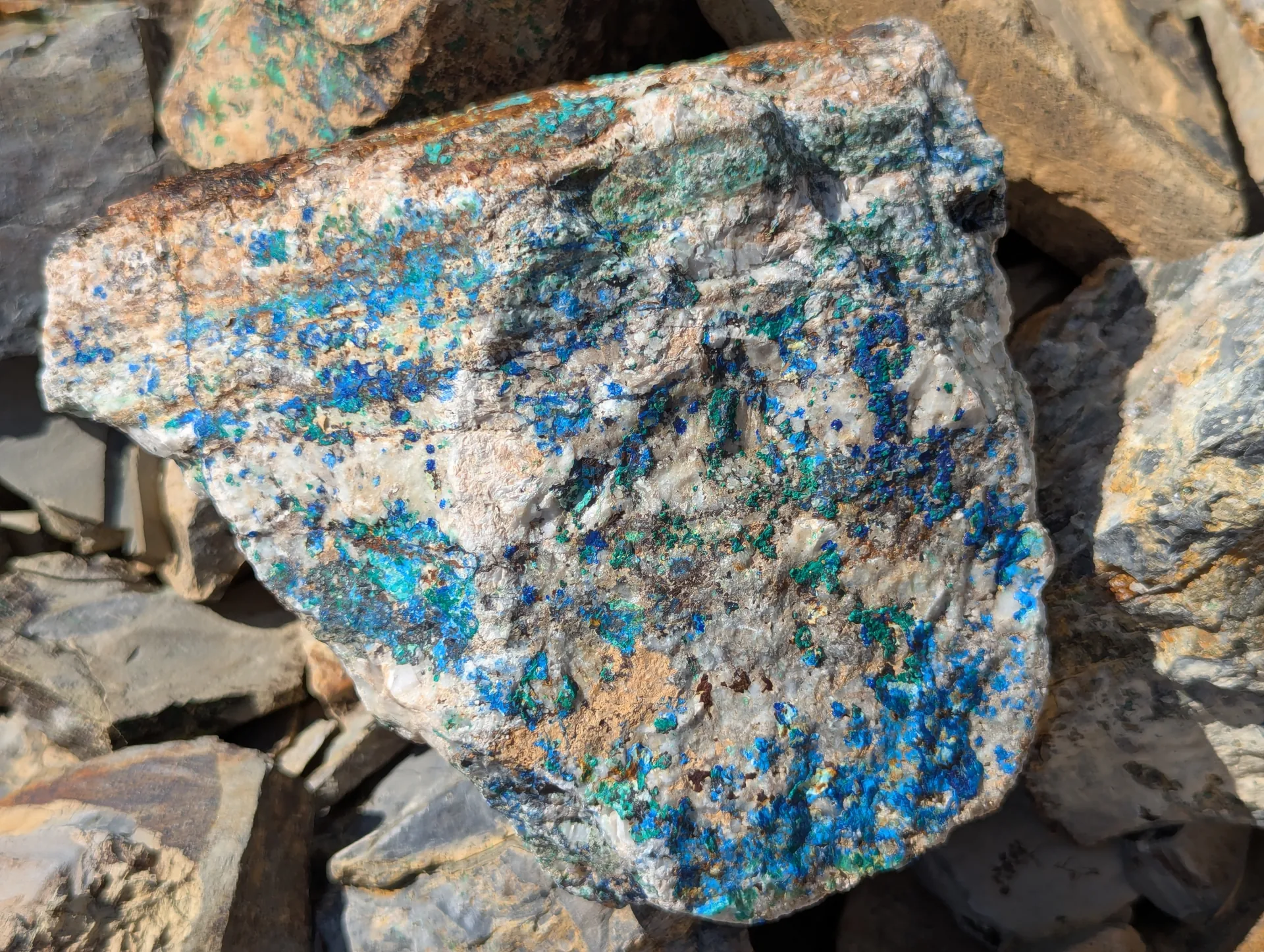 Azurite and malachite densely speckled through quartz-carbonate from the workings.