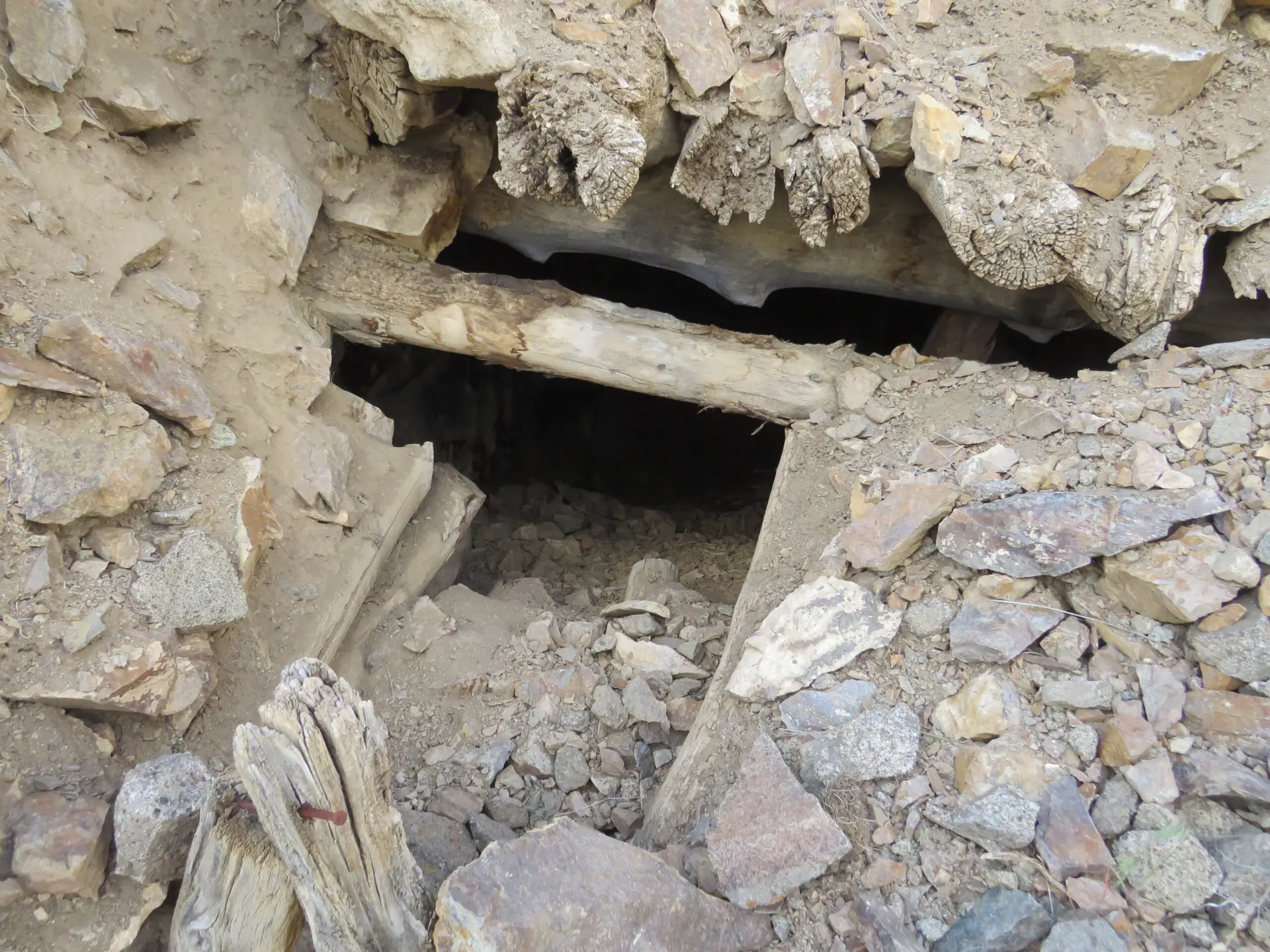 Close-up of collapsed mine portal timbers and entry void