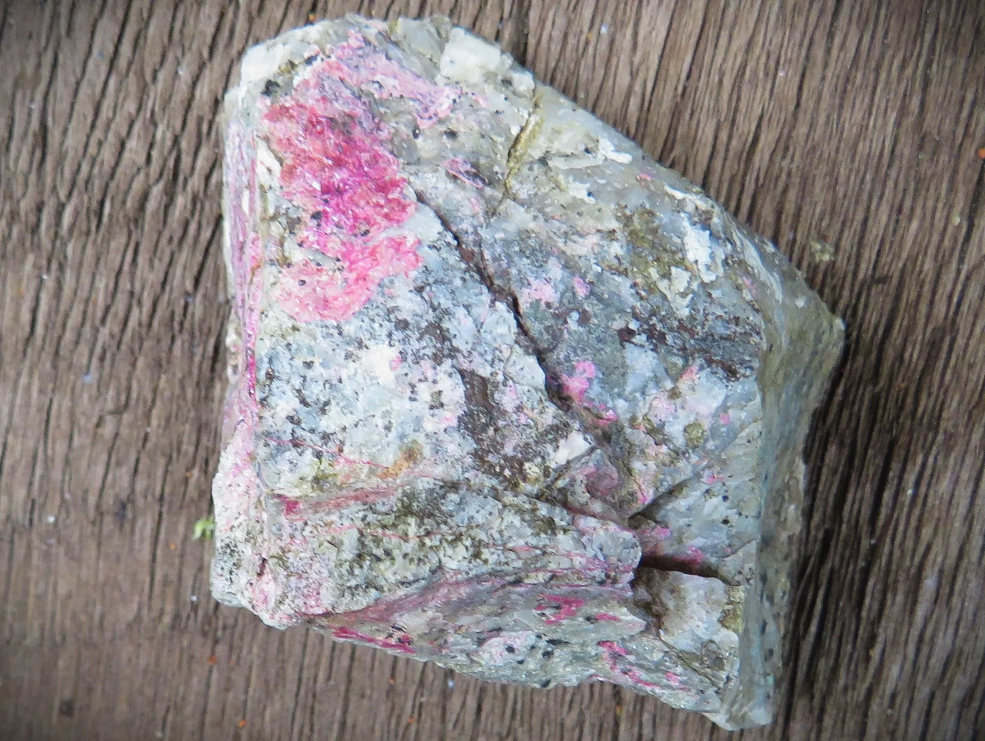 Erythrite (cobalt bloom) on dump material from an old adit.